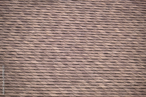 Closeup of house roof top covered with asphalt or bitumen shingles. Waterproofing of new building