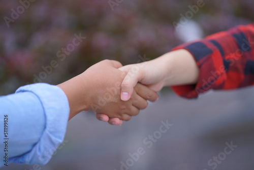 couple holding hands together. handshake between two businessmen. close up of two hands shaking hands