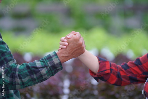 couple holding hands together. handshake between two businessmen. close up of two hands shaking hands