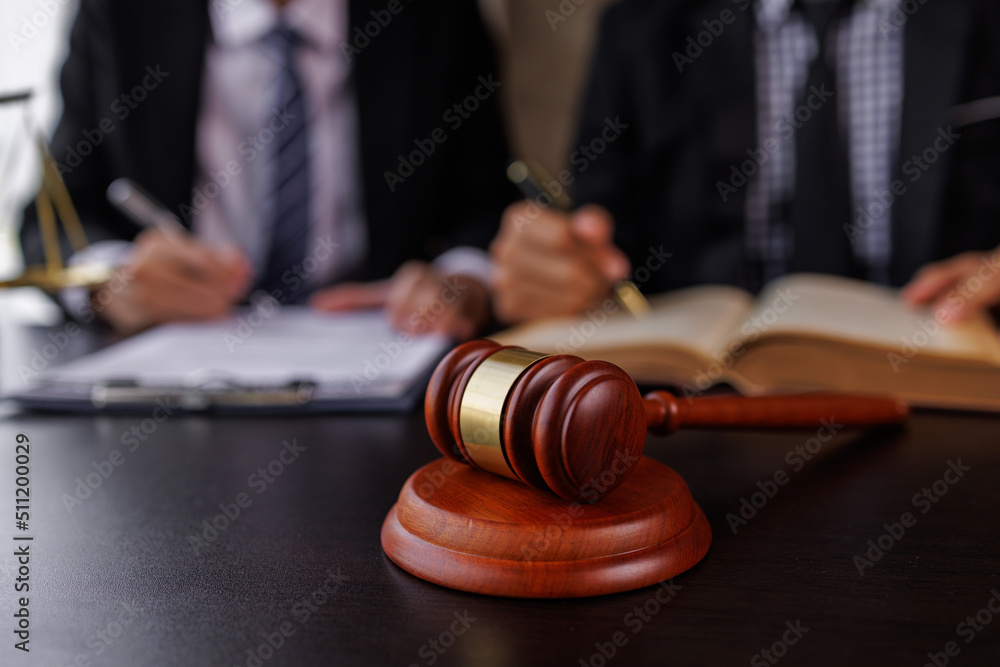 justice and law concept. male lawyer working in an office. Legal law, advice, and justice concept. The client is bringing the documents to clarify the law to the lawyer at the prosecutor's office. justice and law concept. male lawyer working in an office. Legal law, advice, and justice concept. The client is bringing the documents to clarify the law to the lawyer at the prosecutor's office.
