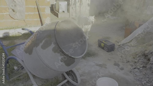 South American builder preparing mortar mixture in mortar construction electric