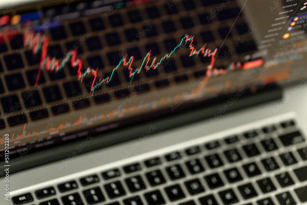 Screen of the laptop with trading chart displayed. Stock market, trend line in a candlestick form. Screen of the laptop with trading chart displayed. Stock market, trend line in a candlestick form.