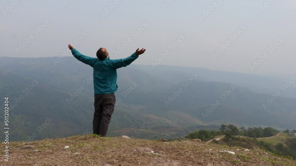 man enjoying nature at hill top with misty mountain rage background from flat angle video is taken at nongjrong meghalaya india. man enjoying nature at hill top with misty mountain rage background from flat angle video is taken at nongjrong meghalaya india.