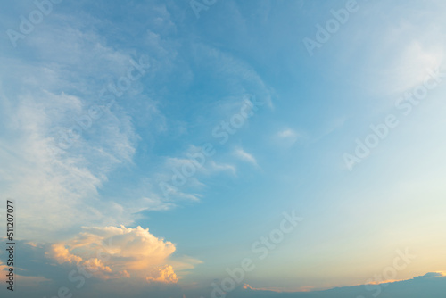 Twilight blue bright and orange yellow dramatic sunset sky in countryside or beach colorful cloudscape texture with white clouds air background.