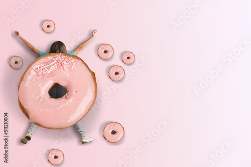 Fototapeta Girl with a donut. Fast food concept, overweight.