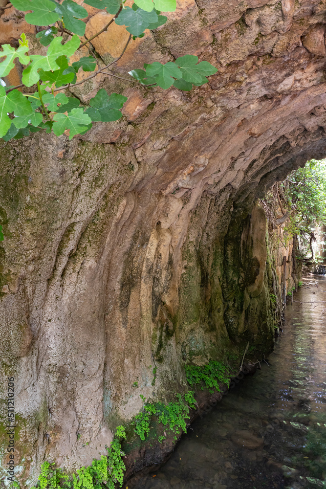 Tunnel  pierced in the mountain by a mountain river in a Hermon Stream Nature Reserve in northern Israel
