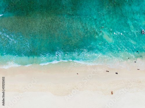 Aerial view of sand beach with tourist people and Beautiful sea waves in Summer tropical background