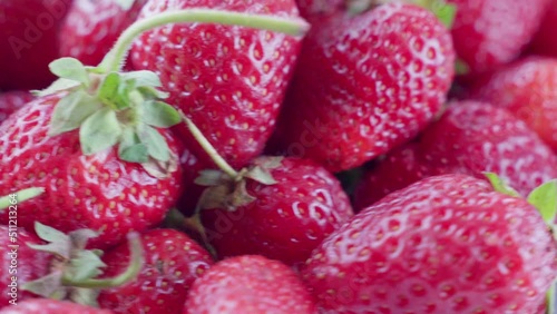 Ripe red strawberries with green leaves, soft focus