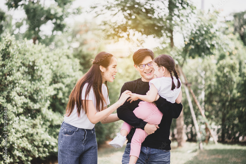 Fototapeta premium Asian family parents and children playing together at park