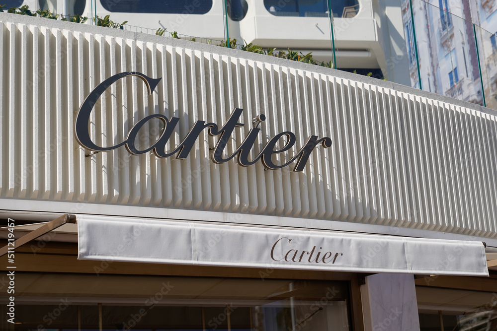 Cartier sign brand and text logo front entrance facade boutique