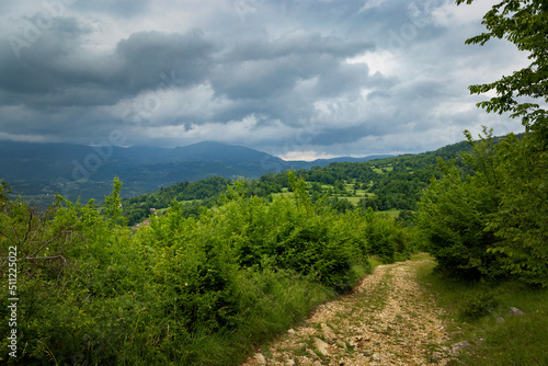 Road in the mountains. Low mountains covered with forest. Balkan mountains.