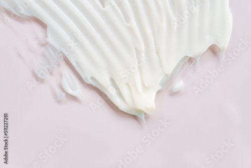 White cosmetic cream smear on beige background with space for text. Skincare product cream texture