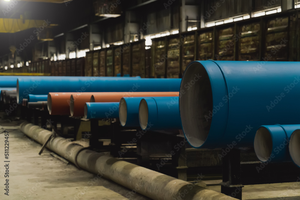 Group of blue metal pipes for water in metallurgical factory warehouse. Group of blue metal pipes for water in metallurgical factory warehouse.