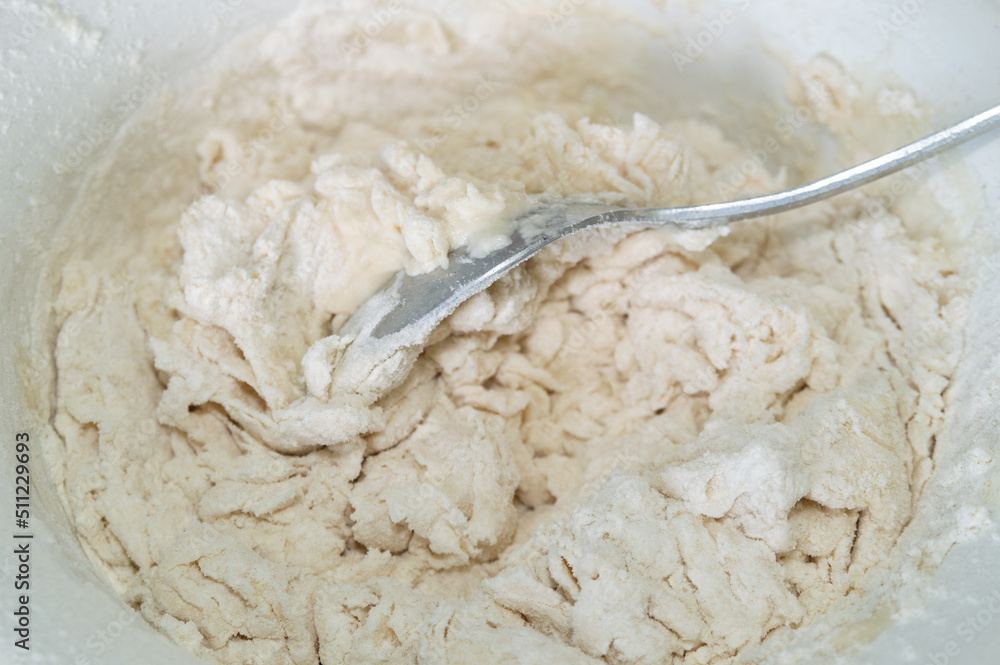 abstract background with kneading the dough in a bowl with a spoon. abstract background with kneading the dough in a bowl with a spoon.