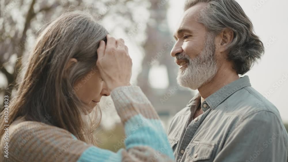 Happy senior couple in Paris. Senior woman and man spending time together at the eiffel tower. Concept about european tourism and landmarks Happy senior couple in Paris. Senior woman and man spending time together at the eiffel tower. Concept about european tourism and landmarks