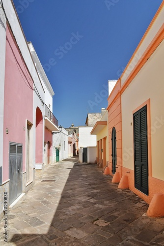 A narrow street between the old houses of Presicce, a picturesque village in the province of Lecce in Italy.