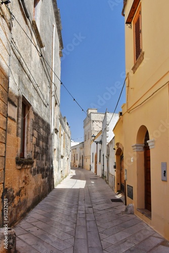 Fototapeta Naklejka Na Ścianę i Meble -  A narrow street between the old houses of Presicce, a picturesque village in the province of Lecce in Italy.