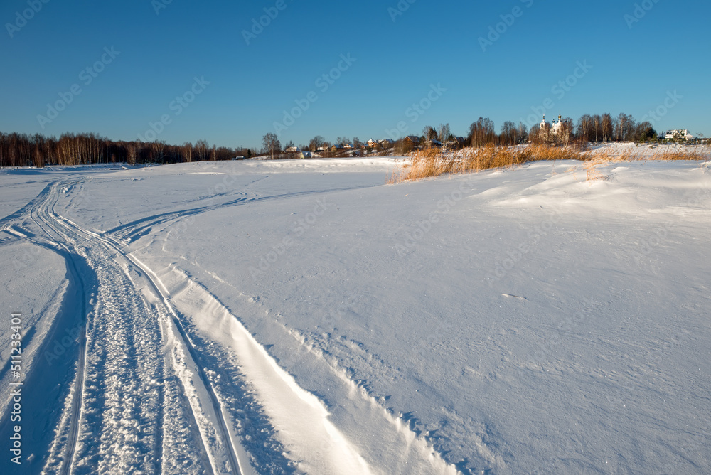 Traces of vehicles and people on the frozen and snow-covered Volga River