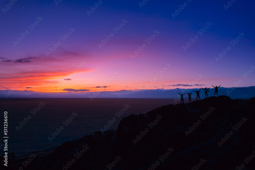 Back view five friends tourists are looking top having fun together sunset mountain Altai. Concept travel trip