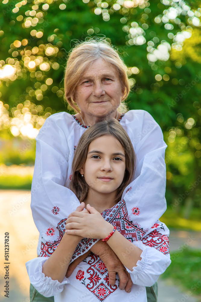 Ukrainian grandmother and granddaughter in vyshyvanka. selective focus. Ukrainian grandmother and granddaughter in vyshyvanka. selective focus.