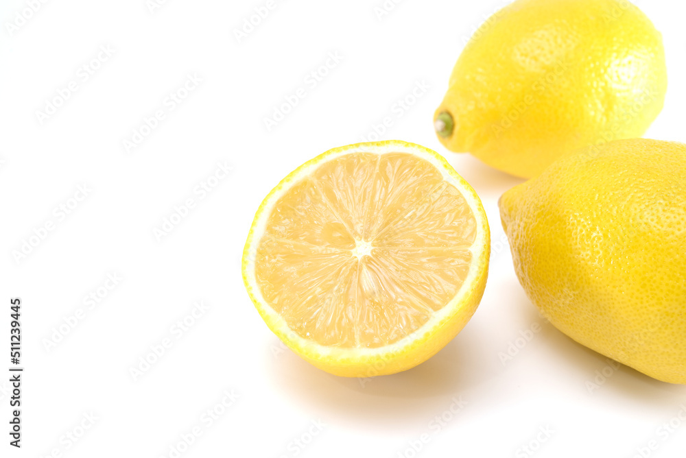 Fresh organic yellow lemon fruit with cut in half isolated on white background Fresh organic yellow lemon fruit with cut in half isolated on white background