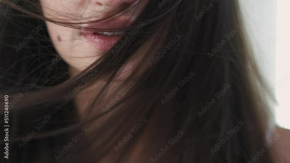 Hair treatment. Tranquil woman. Beauty care therapy. Pretty calm lady posing with smooth long brunette hair ion light background slow motion. Hair treatment. Tranquil woman. Beauty care therapy. Pretty calm lady posing with smooth long brunette hair ion light background slow motion.