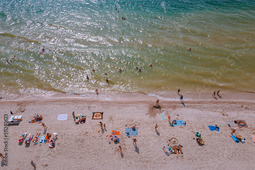 Rest on the seashore. Resort place. "Fedotov braid". located in Kyrylivka in southern Ukraine. View from above. Sea of ​​Azov. The family is relaxing on the beach. Girl, woman, man, boy