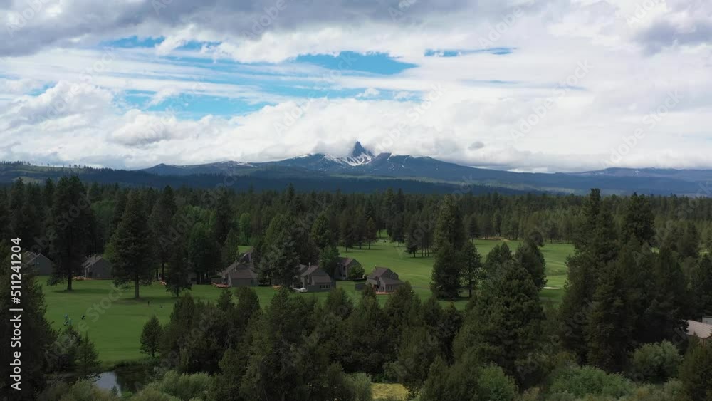 Aerial ascending view of a nice golf course surrounded by evergreen trees in the Cascade Mountain Range of rural Oregon. Aerial ascending view of a nice golf course surrounded by evergreen trees in the Cascade Mountain Range of rural Oregon.