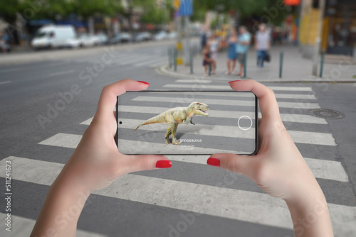 3d projection of dinosaurs on the street with smart phone and augmented reality technology concept photo