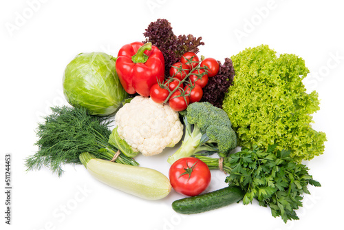 Variety of organic vegetables cabbages, zucchini and leafy greens isolated on white