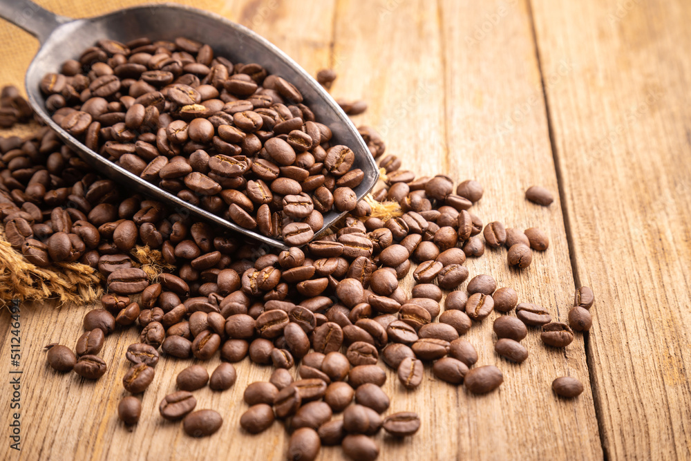 Coffee bean on wooden table background. Food and beverage concept