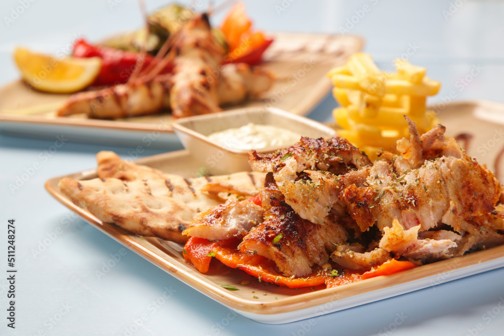 Greek style barbeque and side dishes served on the restaurant table Greek style barbeque and side dishes served on the restaurant table
