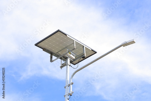 The street light uses solar powered technology against the background of a bright blue sky