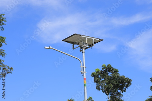 The street light uses solar powered technology against the background of a bright blue sky