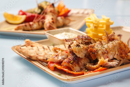 Greek style barbeque and side dishes served on the restaurant table