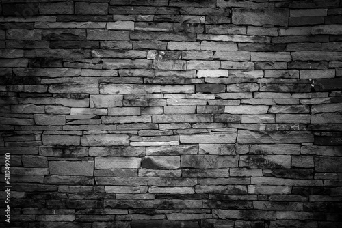 Old vintage retro style dark bricks wall for abstract brick and stone work background and texture.