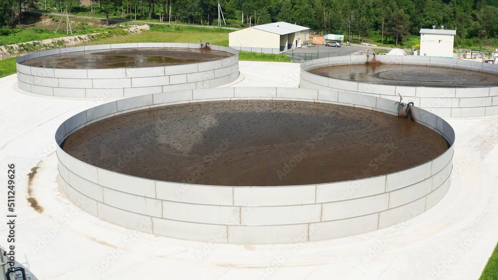 Tanks with liquid manure on the territory of a livestock farm. Aerial view. Tanks with liquid manure on the territory of a livestock farm. Aerial view.