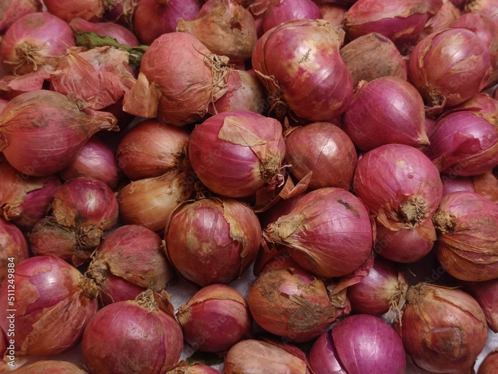 red onions on market, red onions arranged on a white background