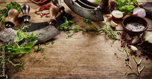 Fototapeta Naklejka Na Ścianę i Meble -  Greens with old fashioned knives on table