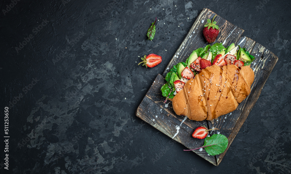 Keto diet Sandwich Croissant with avocado, strawberries, brie camembert