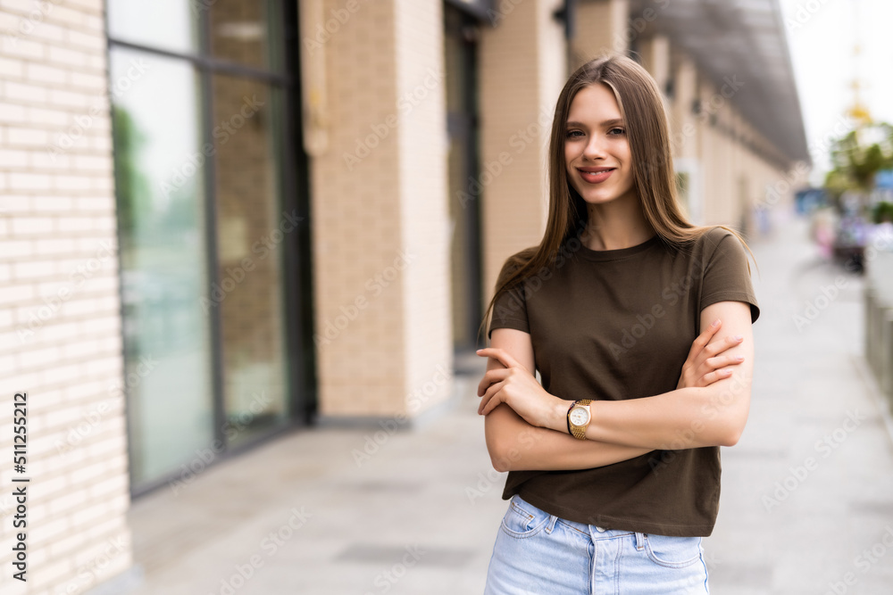 Portrait of a young happy and pretty woman on the street