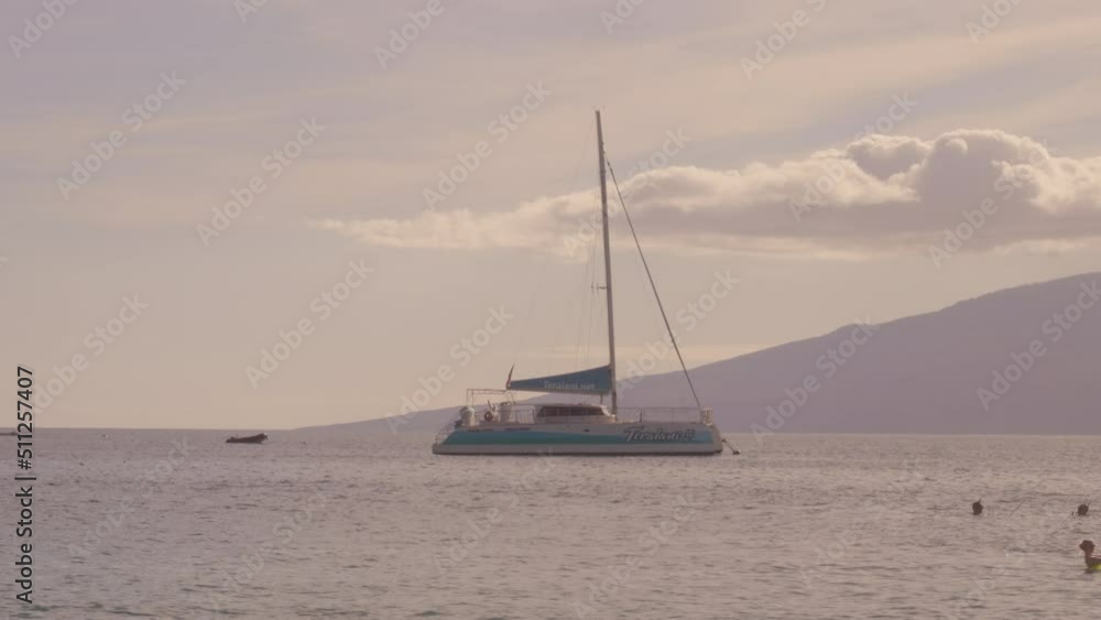 A cinematic view of a sailboat in the sea in the evening sunlight over beautiful big mountains background, luxury summer adventure A cinematic view of a sailboat in the sea in the evening sunlight over beautiful big mountains background, luxury summer adventure