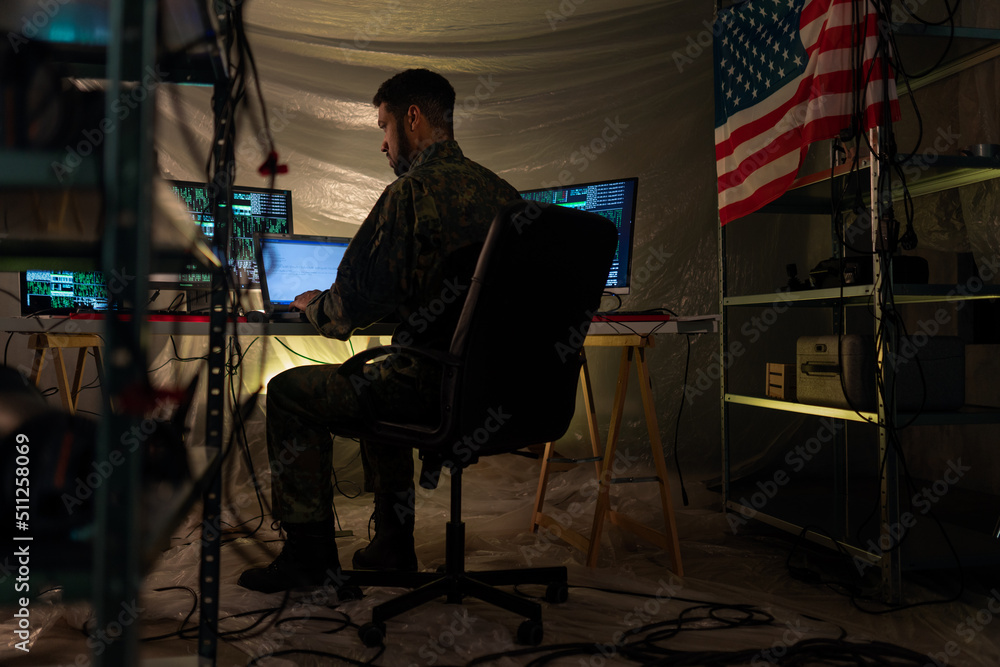 American hacker in military unifrorm on dark web, cyberwar concept. American hacker in military unifrorm on dark web, cyberwar concept.