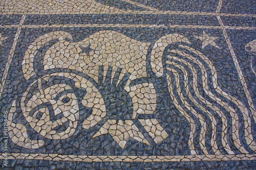 Traditional pattern cobblestone pavement (calçada portuguesa) with image of fish zodiac sign in Belem, Lisbon, Portugal Traditional pattern cobblestone pavement (calçada portuguesa) with image of fish zodiac sign in Belem, Lisbon, Portugal