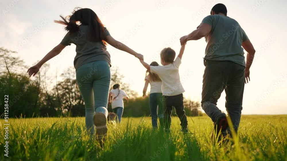 happy family running in the park in summer. mom and dad hold their son by the hands run throw up in the forest park on the grass in the summer. happy family kid lifestyle dream concept happy family running in the park in summer. mom and dad hold their son by the hands run throw up in the forest park on the grass in the summer. happy family kid lifestyle dream concept