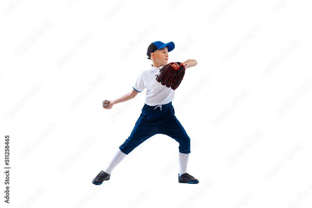 Little boy, baseball player, pitcher in blue-white uniform training isolated on white studio background. Concept of sport, achievements, studying, competition.