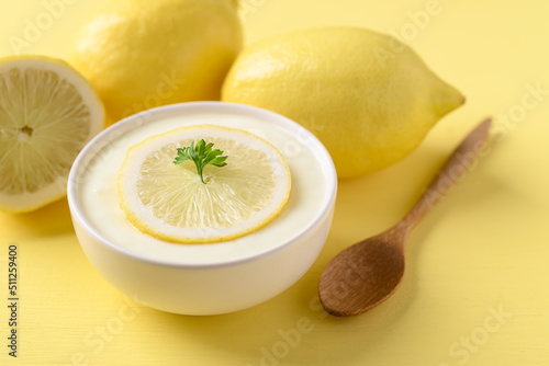 Lemon yogurt in bowl on yellow, Healthy eating and beauty skincare