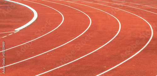 close up of a curved red athletics track in a sports facility