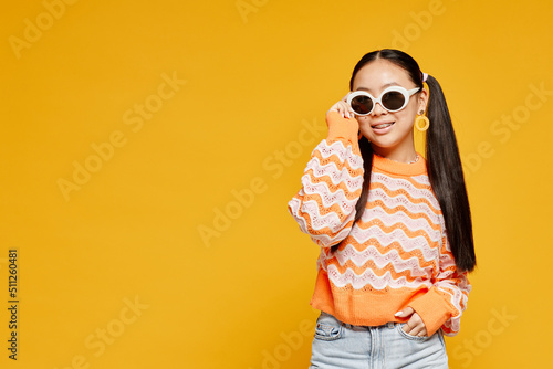Canvastavla Waist up portrait of teenage girl with pigtails over vibrant yellow background,