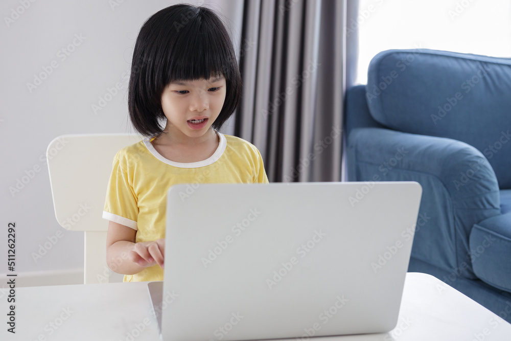 little asian girl student study online using laptop computer at home little asian girl student study online using laptop computer at home